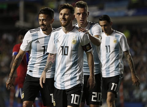 Argentina's Manuel Lanzini(L), Giovanni Lo Celso(SL), and Angel Di Maria (R) congratulate teammate Lionel Messi after his hat trick during a friendly against Haiti. | AP
