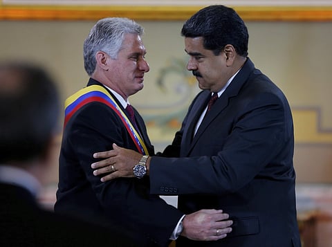 Cuba's President Miguel DIaz-Canel, left, is embraced by his Venezuelan counterpart Nicolas Maduro after being awarded the 'Orden del Libertador Simon Bolivar,' at Miraflores Presidential Palace in Caracas, Venezuela, Wednesday, May 30, 2018. | Associated