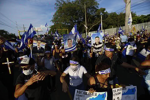 Demonstrators carry pictures of those killed during the ongoing clashes during a march against Nicaragua's President Daniel Ortega in Managua, Nicaragua. | AP