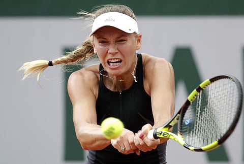 Caroline Wozniacki returns the ball to Georgina Garcia Perez during their second round match of the French Open tournament at the Roland Garros stadium. | AP