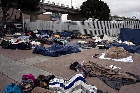 Central American migrants travelling in the 'Migrant Via Crucis' caravan sleep outside 'El Chaparral' port of entry to US. (File Photo| AFP)