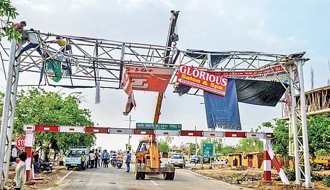 Authorities pull down a damaged hoarding near Bharatpur district