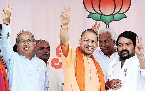 UP CM Yogi Adityanath and BJP candidate for Mudhol constituency Govind Karjol (left) at an election rally in Mudhol on Friday