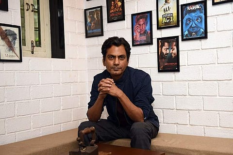 In this photo taken on May 1, 2018, Indian Bollywood actor Nawazuddin Siddiqui poses during an interview with AFP at his office in Mumbai. | AFP