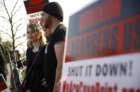 In this April 18, 2018 photo, Chelsea Manning, left, attends an anti-fracking rally in Baltimore. | Associated Press