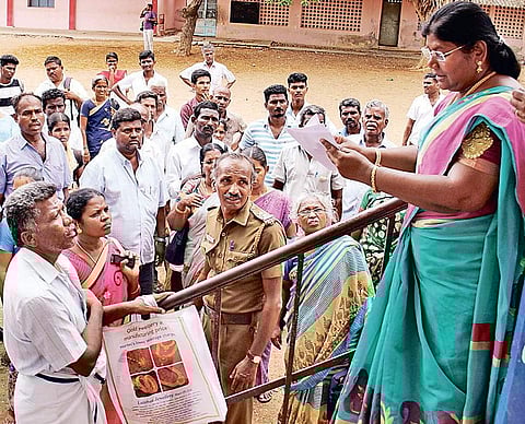 An official reading out the list of students who are yet to write the NEET at Noyes MHS School exam centre in Madurai on Sunday | k k sundar