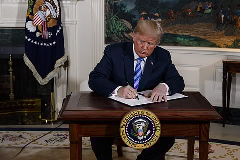 President Donald Trump signs a Presidential Memorandum on the Iran nuclear deal from the Diplomatic Reception Room of the White House. (AP)