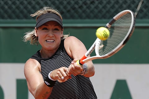 Bethanie Mattek-Sands returns the ball to Andrea Petkovic during their second round match of the French Open tennis tournament at the Roland Garros stadium. | AP