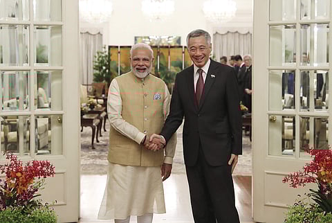 Modi along with Singapore's Minister of Education Ong Kung and President of the varsity Subra Suresh planted the tree in commemoration of the Prime Minister's visit to the university. (Photo | AP)