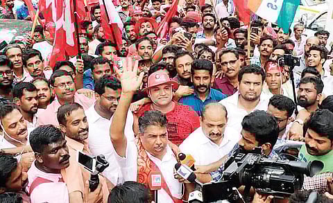 Left Democratic Front’s Saji Cheriyan acknowledges supporters’ cheers during his victory parade | express