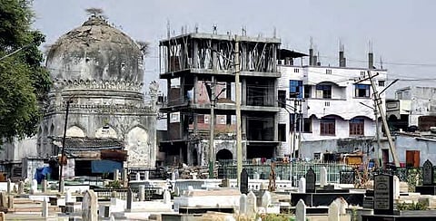 With no boundary wall to protect Daira-e-Mir Momin, new buildings have encroached the monument in the city | vinay madapu