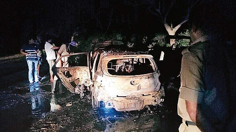 The gutted vehicle in which two bodies were recovered near Pushpagiri hill in Belur