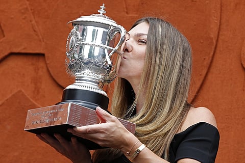 Romania's Simona Halep kisses with the cup at the Roland Garros stadium | AP