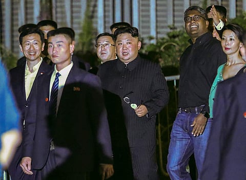 North Korea leader Kim Jong Un, center, is escorted by his security delegation as he visits Marina Bay in Singapore. | AP