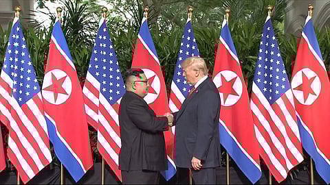 In this image made from video provided by Host Broadcaster Mediacorp Pte Ltd, U.S. President Donald Trump and North Korean leader Kim Jong Un shake hands ahead of their meeting at Capella Hotel in Singapore, Tuesday, June 12, 2018. | AP