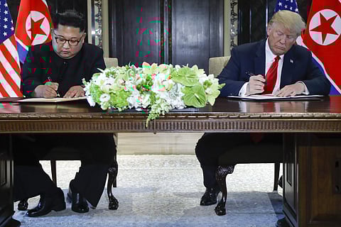 North Korea leader Kim Jong Un and U.S. President Donald Trump sign documents after their meetings at the Capella resort on Sentosa Island Tuesday, June 12, 2018 in Singapore. (Photo: AP)