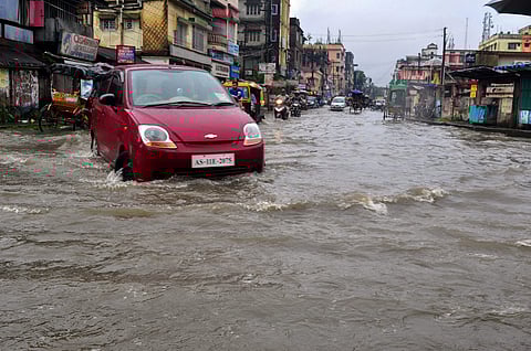 A car wades through a flooded street after heavy downpour in Silchar Assam on Thursday June 14 2018. (Photo | PTI)