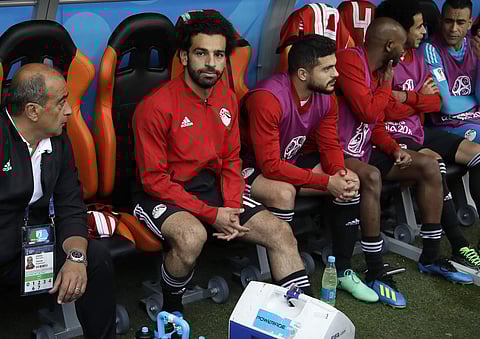 Egypt's Mohamed Salah, second left, sits on the bench ahead the group A match between Egypt and Uruguay at the 2018 soccer World Cup in the Yekaterinburg Arena in Yekaterinburg. | AP