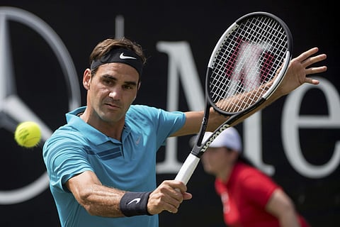 Roger Federer returns the ball to Guido Pella in their quarterfinal match during the ATP Mercedes Cup in Stuttgart. | AP