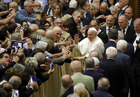 Pope Francis greets members of an association of people honored by the Italian Presidency for their commitment to their work, in the Paul VI Hall at the Vatican. | AP