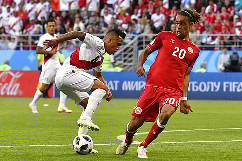 Peru's Christian Cueva, left, duels for the ball with Denmark's Yussuf Yurary Poulsen during the group C match between Peru and Denmark. | AP
