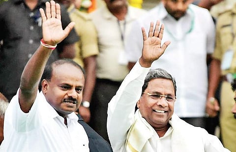 Chief Minister H D Kumaraswamy and former CM Siddaramaiah wave to the crowd