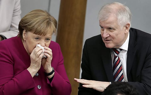 German Chancellor Angela Merkel, left, and German Interior Minister Horst Seehofer, right, talk during a meeting of the German federal parliament, Bundestag, in Berlin. (File Photo | AP)