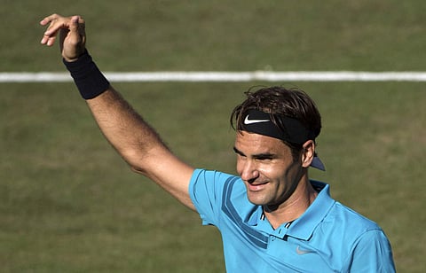 Roger Federer celebrates winning the finals tennis match against Milos Raonic during the ATP Mercedes Cup in Stuttgart. (AP)