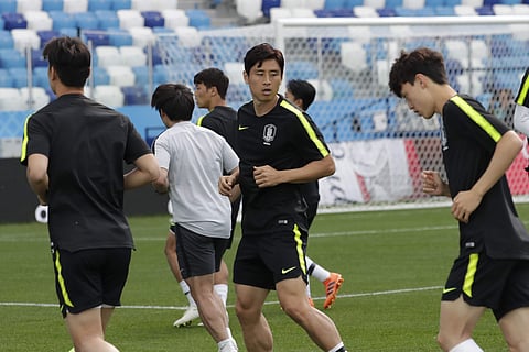 South Korea's Koo Ja-cheol, center, warms up during South Korea's official training on the eve of the group F match between Sweden and South Korea at the 2018 soccer World Cup in the Nizhny Novgorod stadium in Nizhny Novgorod, Russia, Sunday, June 17, 201