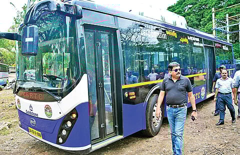 KSRTC chairman and managing director Tomin J Thachankary standing beside the electric bus which arrived at KSRTC central workshop at Pappanamcode in Thiruvananthapuram on Sunday | B P Deepu
