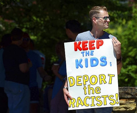 In this June 15, 2018 file photo, Chris Olson, of Lake Wallenpaupack, Pa., holds a sign outside Lackawanna College where U.S. Attorney Jeff Sessions spoke on immigration policy and law enforcement actions, in Scranton, Pa. (AP)