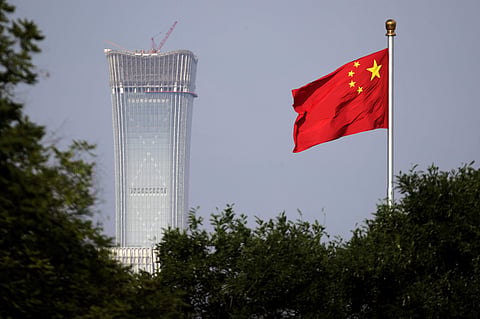 A Chinese national flag flutters against the Beijing's tallest skyscraper China Zun Tower. | AP