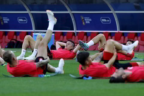 Poland's Robert Lewandowski, center, warms up during Poland's official training on the eve of the group H match between Poland and Senegal at the 2018 FIFA World Cup in the Spartak Stadium in Moscow. (AP)