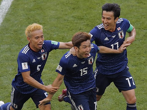 Japan's Yuya Osako, centre, celebrates after scoring his side's 2nd goal with teammates Makoto Hasebe, right, and Yuto Nagatomo, left, during the group H match between Colombia and Japan at the 2018 FIFA World Cup in the Mordavia Arena in Saransk. (AP)