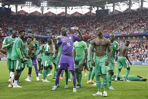 Senegal's team players celebrate as they won the group H match between Poland and Senegal at the 2018 FIFA World Cup in the Spartak Stadium in Moscow. (AP)