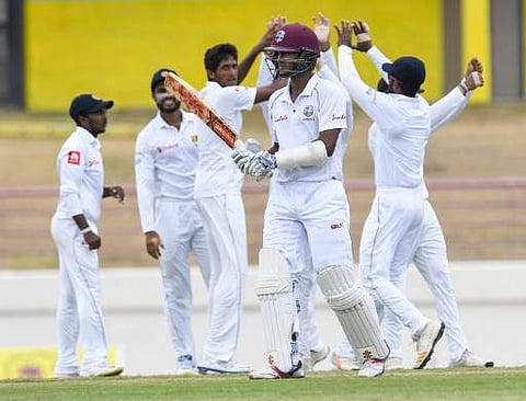 Kasun Rajitha (L) of Sri Lanka celebrates the dismissal of Kraigg Brathwaite (R) of West Indies during day 2 of the 2nd Test between West Indies and Sri Lanka at Daren Sammy Cricket Ground, Gros Islet, St. Lucia, on June 15, 2018. | AFP