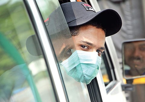In the wake of the Nipah virus outbreak, a car passenger sports a protective mask in Kozhikode on Friday | T P Sooraj