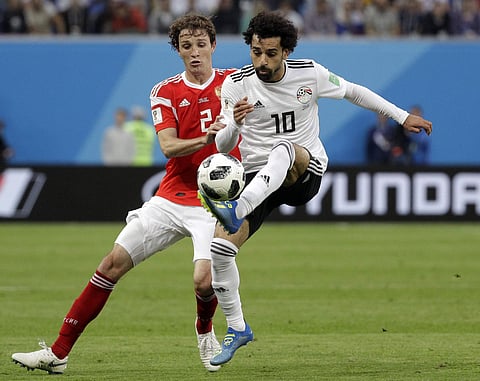Russia's Mario Fernandes, left, challenges for the ball Egypt's Mohamed Salah, right, during the group A match between Russia and Egypt at the 2018 soccer World Cup in the St. Petersburg stadium in St. Petersburg, Russia, Tuesday, June 19, 2018. | AP