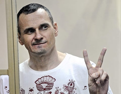 FILE - In this Tuesday, Aug. 25, 2015 file photo, Oleg Sentsov gestures as the verdict is delivered, as he stands behind bars at a court in Rostov-on-Don, Russia. | AP