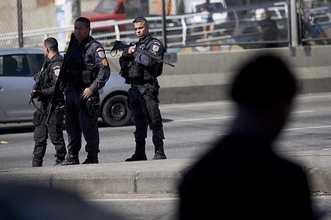Police officers arrive to control a protest of students and friends of Marcos Vinicius, 14, a boy who was shot and killed by a stray bullet during a civil police and military operation at the Mare slum, in Rio de Janeiro, Brazil (Photo|AP)