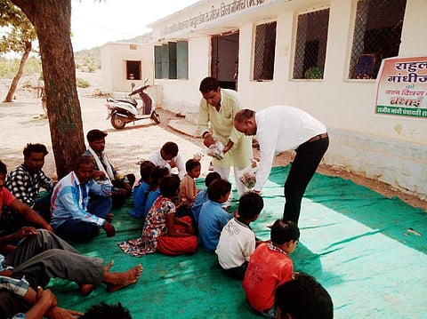 Congress leader Ramesh Rajora at the government school in Madhay Pradesh on Rahul Gandhi's birthday (Express Photo)