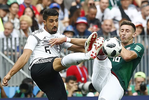 Germany's Sami Khedira, left, was often out of position in the defensive midfield when Mexico counter-attacked through the German ranks. (AP)