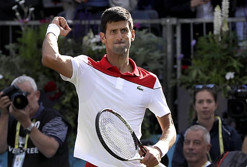 Novak Djokovic of Serbia celebrates winning his match against Grigor Dimitrov of Bulgaria during their singles tennis match at the Queen's Club tennis tournament in London. (AP)
