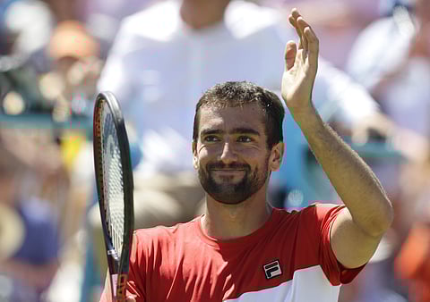 Marin Cilic of Croatia celebrates winning his quarterfinal tennis match against Sam Querrey of the USA during their at the Queen's Club tennis tournament in London. (AP)