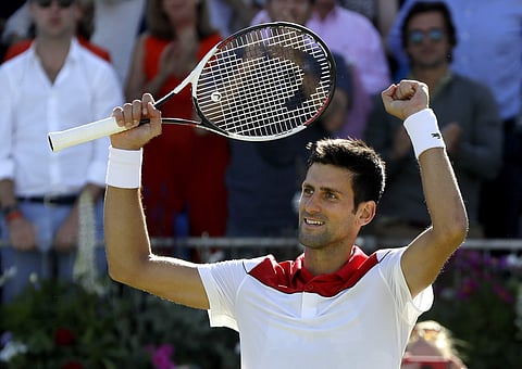 Novak Djokovic of Serbia celebrates winning his quarterfinal tennis match against Adrian Mannarino of France at the Queen's Club tennis tournament in London. (AP)