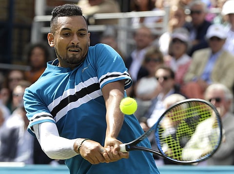 Nick Kyrgios of Australia plays a return to Kyle Edmund of Britain during their singles tennis match at the Queen's Club tennis tournament in London, Thursday, June 21, 2018. | AP