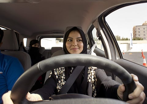 A student at the female-only campus of Effat University, sits for the first time in the driver's seat, during training sponsored by Ford Motor, in Jiddah, Saudi Arabia. | AP