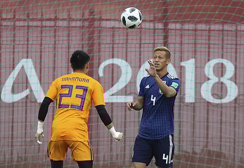 Japan's Keisuke Honda, right, and Kosuke Nakamura, left, warm up during a training session venue of Japan national team at the 2018 soccer World Cup in Kazan, Russia, Friday, June 15, 2018. | AP