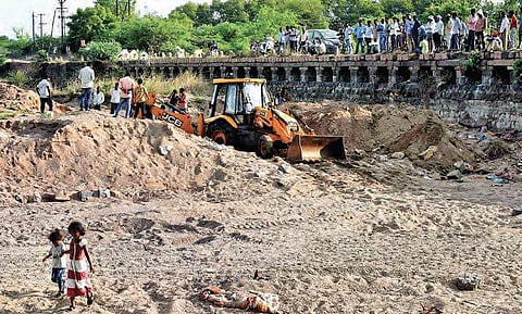 Revenue authorities excavating the Irukulla vagu, in Karimnagar on Saturday to find the mortal remains of four persons who were washed away in floods | EXPRESS