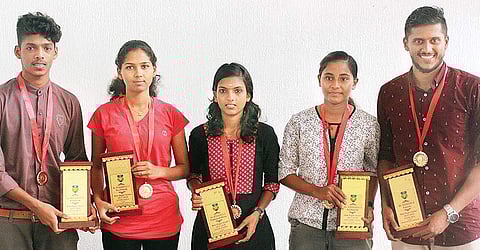 Kerala Footballer of the Year award winners Mohammed Shafeeq E P (junior boys), Krishnapriya A T (junior girls), Athulya K V (senior women), Vismayaraj P (sub-junior girls) and Midhun V (senior men) with their awards | EXPRESS